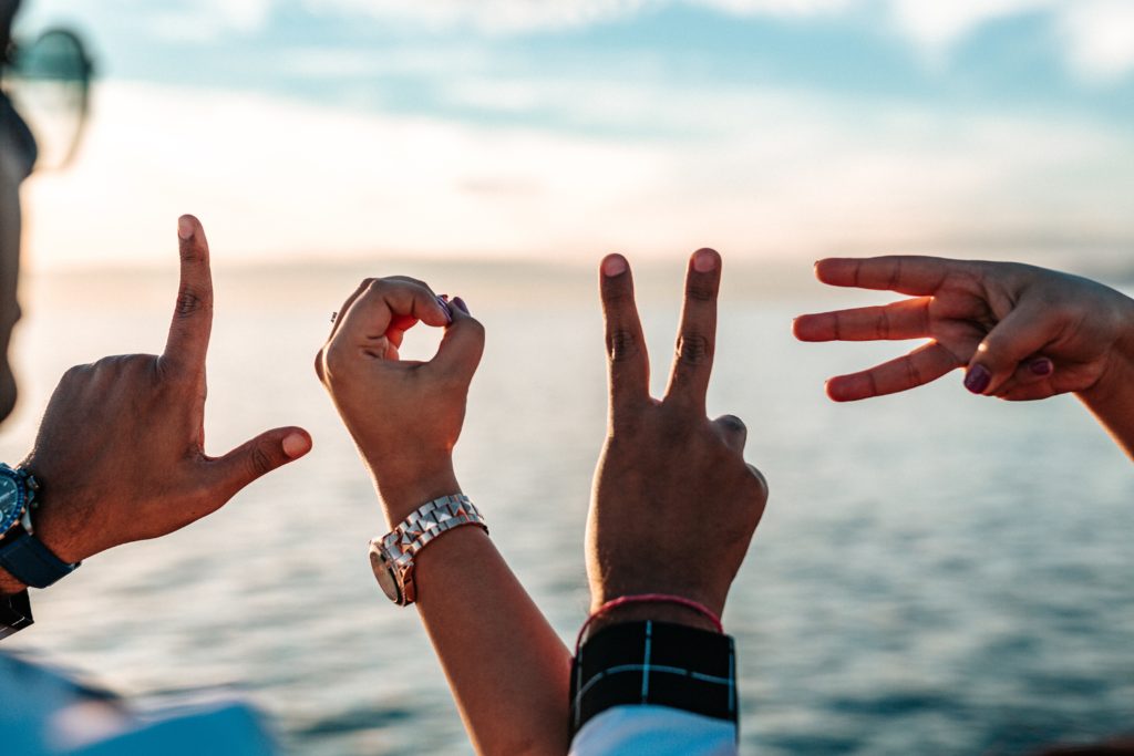 Hands Forming the Word "Love"