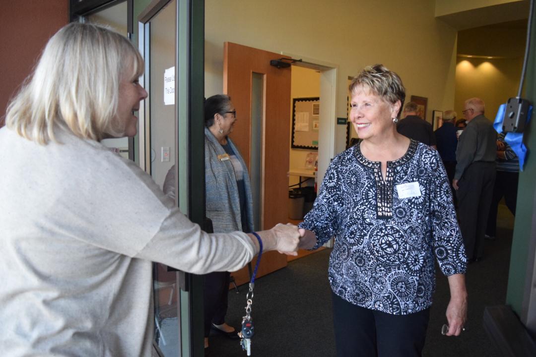 Two People Smiling and Shaking Hands